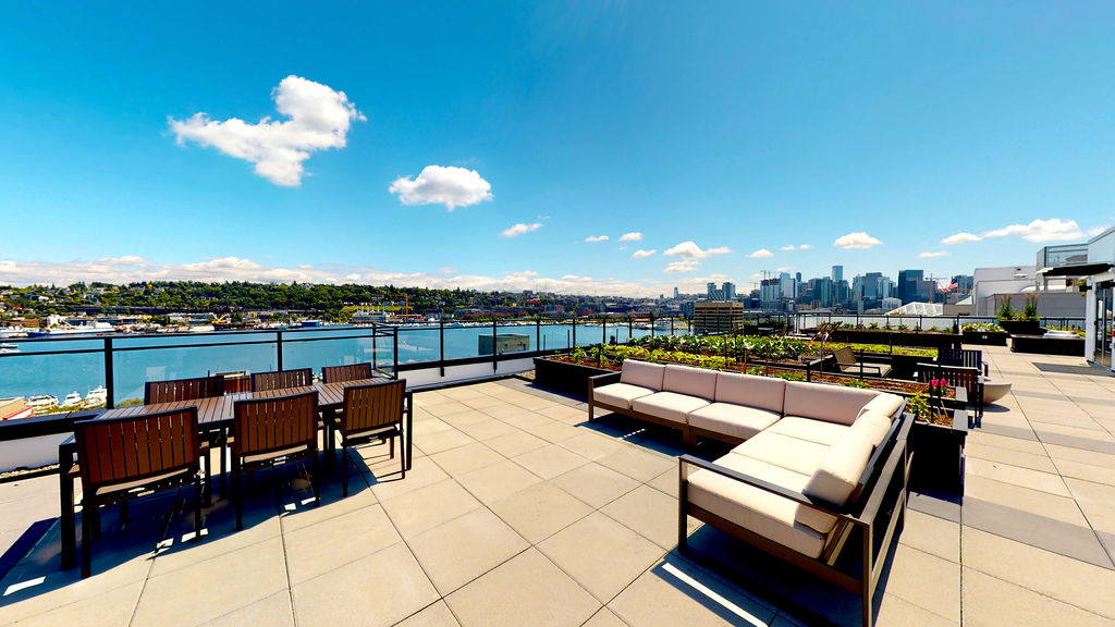 Rooftop terrace with lounge seating and skyline views at Contour Apartments