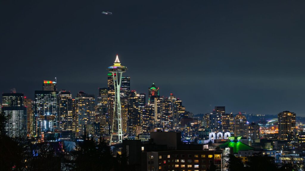 Holiday lights in the trees at Seattle Center with the Space Needle at night
